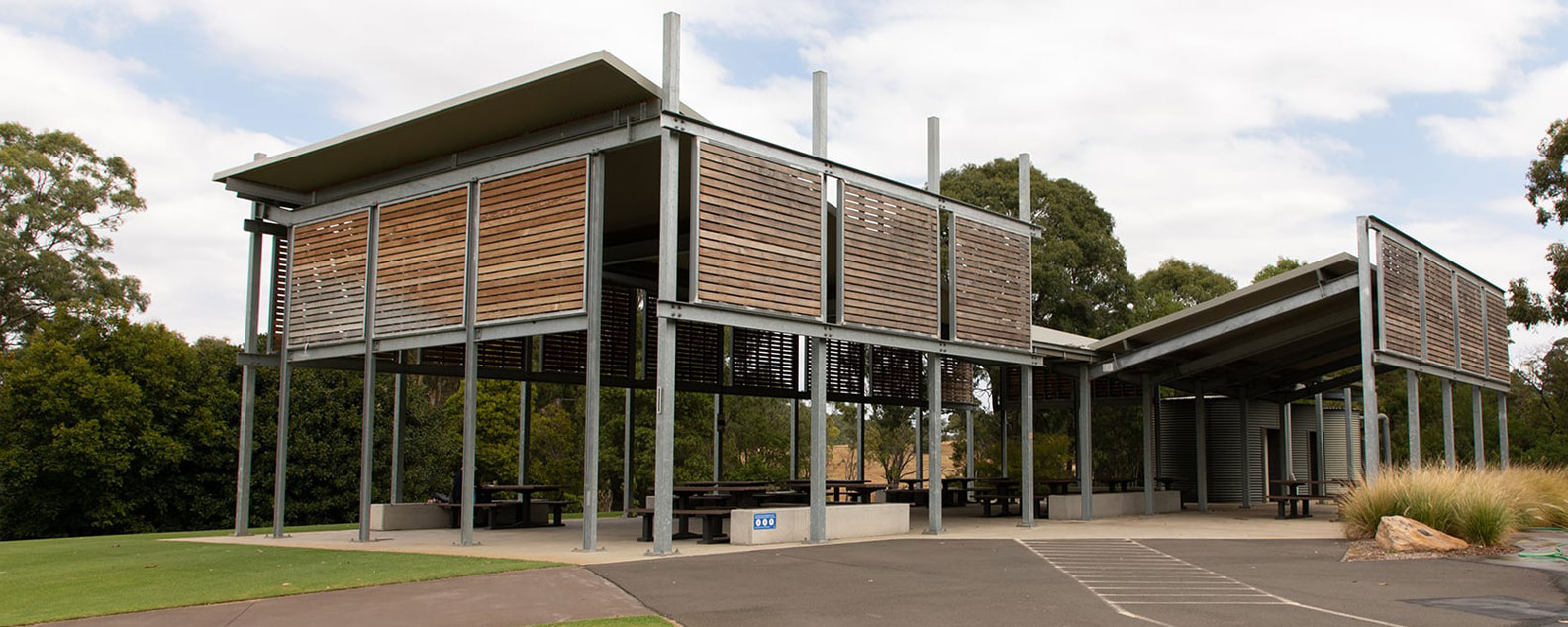 Road leading up to the Lakeside Pavilion and trees in the background