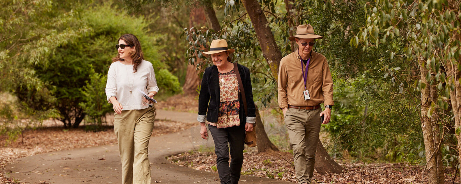 Three people walking along a Garden path. Credit: Tawfik Elgazzar