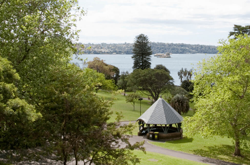 Aerial view of picnic shelter among trees and with Sydney Harbour in background