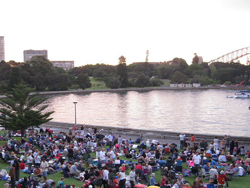 people picnicking on Sydney Harbour shoreline at Royal Botanic Garden Sydney