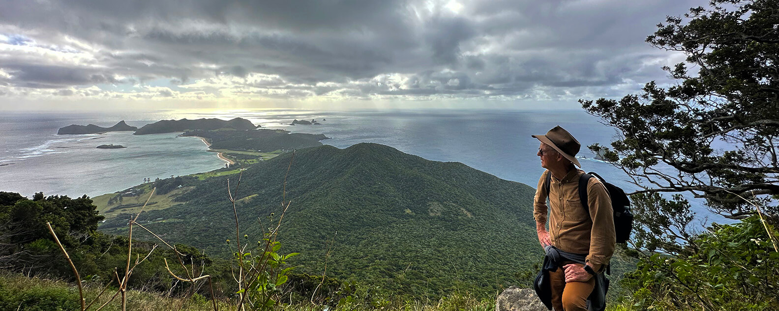 Professor Brett Summerell stands on a mountain range at Lord Howe Island