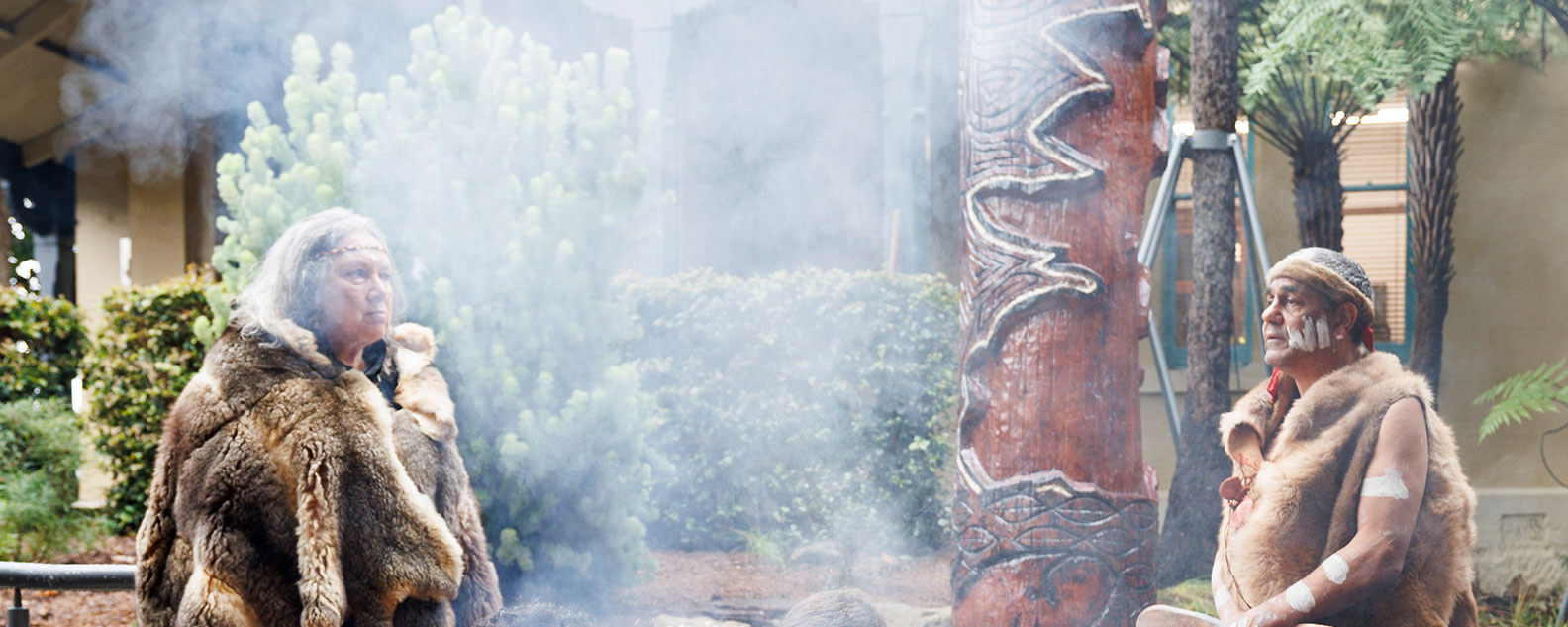 Aunty Rhonda Dixon-Grosvenor and Uncle Dean Kelly smoking and welcoming Yer’ung – Spirit Tree to its home at the Royal Botanic Garden Sydney