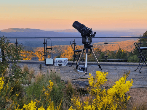 A telescope on a viewing deck overlooking the Blue Mountains