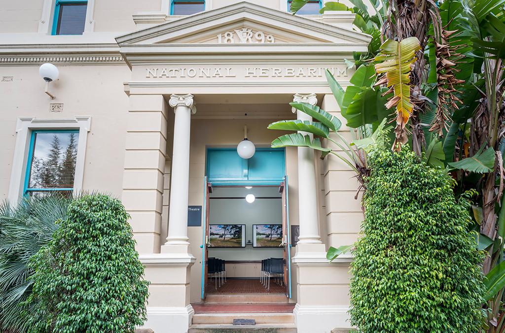 Cream-coloured heritage building with Greek columns at the entrance
